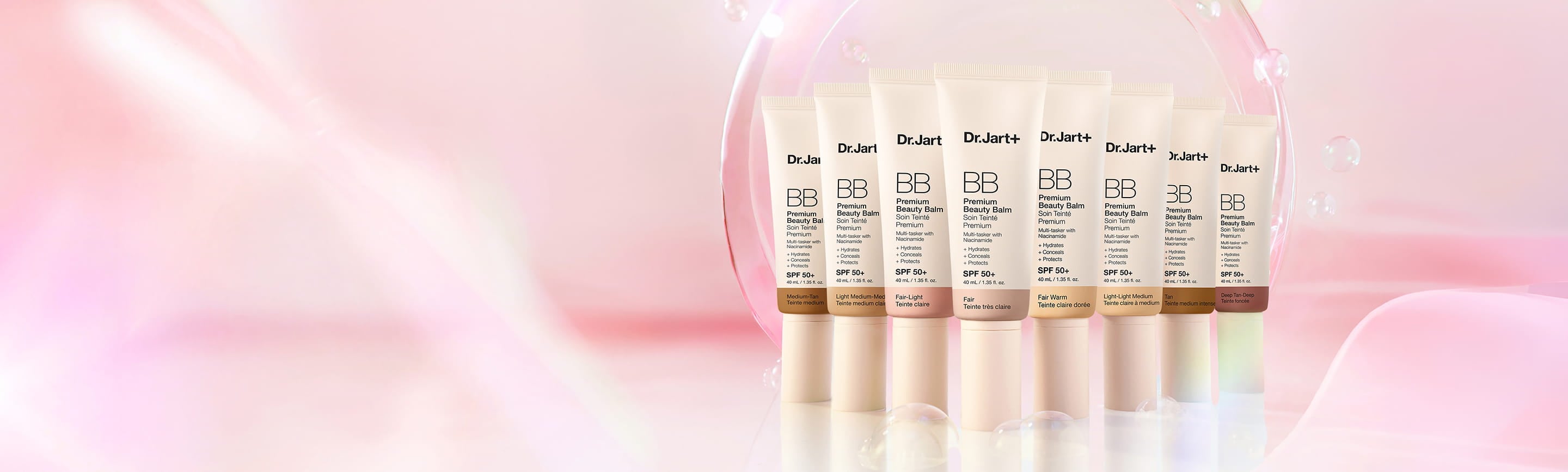 Lineup of new BB Premium Beauty Palm SPF 50 products in front of a dynamic pink background, surrounded by bubbles